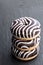 Chocolate ripple stripe doughnut on black stone background