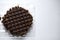 Chocolate round waffle cookies on a white background