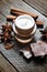 Chocolate skin treatment. Cosmetic jar with lotion, cocoa, anise, cinnamon sticks.