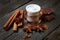 Chocolate skin treatment. Cosmetic jar with lotion, cocoa, anise, cinnamon sticks.