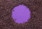 Chocolate sprinkles covering a purple background leaving a circle in centre for text