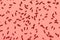 chocolate sprinkles over trendy color living coral background, decoration for cake and bakery, flat lay