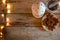 Chocolate star cookies, pestle and mortar with star anise and white lantern in rustic wooden table with Christmas lights