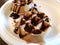 Chocolate syrup liquid on waffles on white plate