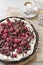 Chocolate tart with raspberries on a vintage background and a cup of fragrant espresso macchiato