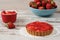 Chocolate tart, tartalette with white chocolate and mascarpone cream, fresh strawberries on top. Large blue bowl full of