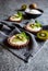 Chocolate tartlets filled with coconut cream and topped with kiwi slices