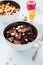 Chocolate tiny pancake cereals with white chocolate drops in a bowls