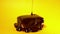 Chocolate topping glaze pouring on biscuit cake dessert on yellow background. Sweet decoration. Cooking, food and baking