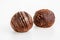 Chocolate truffle candies covered with flowing chocolate and cocoa powder isolated on white background. Macro