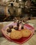 Chocolate turtles and palm trees on a sugar beach with cookies on a red glass plate and a backdrop of an Oriental garden