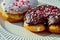 Chocolate and vanilla heart donuts with tiny red heart sprinkles on top