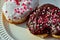 Chocolate and vanilla heart donuts with tiny red heart sprinkles on top