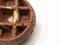 chocolate waffle with almond slide on a white plate, fresh baked for sweet meal, dessert concept