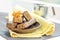 Chocolate waffles and a jug of milk on a yellow napkin with orange flowers