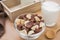 Chocolate and white chocolate cereals in bowl with milk glass