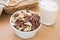 Chocolate and white chocolate cereals in bowl with milk glass