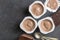 Chocolate yogurt cups on black mottled background with small silver spoons - Three chocolate flavoured yoghurt cups with dark