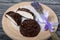 A chocolate zephyr made in the shape of a rose lies on a white napkin. One zephyr is cut in half, a slice is visible. Near a