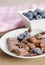 Chocolates and cocoa powder with blueberries in a porcelain dish