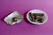 Chocolates, white saucer and candy wrapper on a pink background