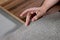 The choice of finishing materials for the design of the house project. The hand of an interior designer selects a palette of