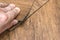 Choice of flooring. Renovation or construction concept. Close-up of a male hand holding a textured vinyl floor tile