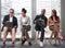 Choices for the future. Shot of a group of businesspeople using their electronic devices against a glass background in