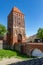 Chojnice, pomorskie / Poland - May, 31, 2020: City walls with an entrance gate. Historic buildings in Central Europe