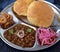 Chole bhature with pickled onions