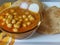 Chole Puri dish in a plate. Chole Poori receipe in a plate. Chickpeas receipe in a plate.