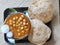 Chole Puri dish in a plate. Chole Poori receipe in a plate. Chickpeas receipe in a plate.