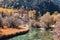 Chong Gu temple on autumn hill with emerald river at Yading