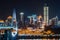 Chongqing skyline at night with a bridge and HongyaDong cave