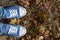 Choose the best A conceptual picture illustrating the teenager`s problem in the life choices. Legs in blue sneakers and blue jean