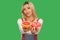 Choose healthy fruit or junk food. Portrait of positive woman showing sweet doughnut and grapefruit