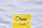 Choose love handwriting text close up isolated on yellow paper with copy space