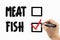 Choose between meat or fish with checkbox. Doodle  on a whiteboard, written with black and red marker in a hand.
