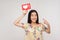 Choose trendy social media content! Happy enthusiastic asian girl in blouse pointing at heart icon over her head
