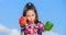 Choose which. Alternative decision concept. Kid girl hold red and green peppers sky background. Kid hold ripe pepper