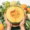 Choosing melon hand selects fresh cantaloupe from supermarket basket