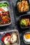 Choosing take away food. Spring rolls, dumplings, gyoza and wok noodles in box. Take and go organic food. White background. Top