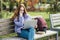 Choosing a university, college. Female college student with books and laptop outdoors. Redhead college student girl with