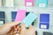 Choosing wall color sample. Man hands holding paper example. Blue or pink choice