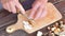 Chop fresh wild mushrooms. Close up shot of hands with a knife cutting mushrooms. Man hand carefully cut wild mushrooms on desk