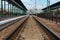 CHOP, UKRAINE, MAY 12, 2016. Chop City Train Station in , Ukraine with railways going in to horizon and arriving train.