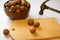 Chop  walnuts with a hammer on a cutting board. strong natural walnuts in  kitchen