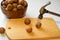 Chop  walnuts with a hammer on a cutting board. strong natural walnuts in  kitchen