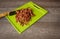 Chopped Bacon on a green cutting board with a carving knife