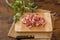 Chopped bacon and parsley on wooden table